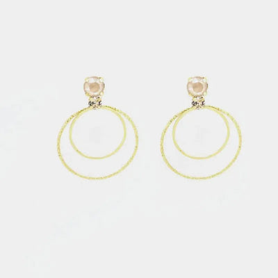 Orecchini in Argento 925 cerchi con cristalli champagne al lobo.