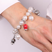 Bracciale in Metallo Bracciale in Metallo con perle e campanelle portafortuna in smalto rosso con scritta Capri