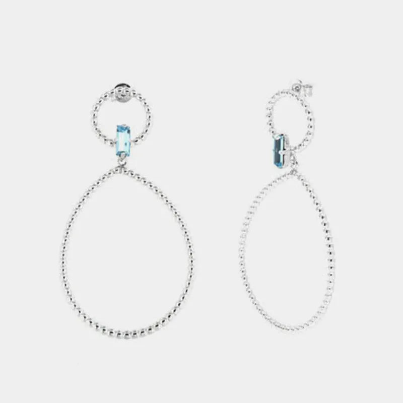 Orecchini in Argento 925 con doppi cerchi puntellati e cristallo azzurro centrale
