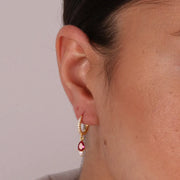 Orecchini in Argento 925 a cerchietto impreziosito da zirconi bianchi e zircone viola pendente