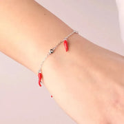 Bracciale in Argento 925 maglia a catena con cristalli bianchi alternati da cornetti portafortuna rossi