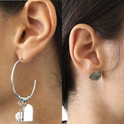 Orecchini in Acciaio da un lato a cerchio con pendenti freccia e cuore lucidi, e dall'altro cuore a lobo lucido