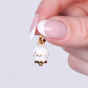 Ciondolo in Acciaio campanella bianca placcata oro con scritta Capri