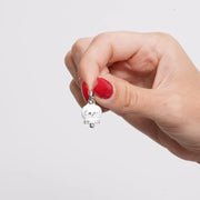 Ciondolo in Acciaio campanella bianca con scritta Capri e zirconi