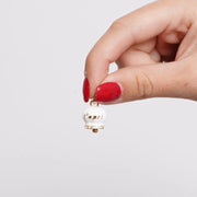 Ciondolo in Acciaio campanella bianca e oro con scritta capri e zirconi