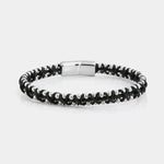 Bracciale in Acciaio rigido in corda nera intrecciata insieme a sferette in metallo lucido. Chiusura a scomparsa