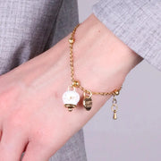 Bracciale in Acciaio con campanella  pendente  bianca  e oro con scritta Capri