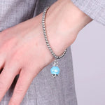 Bracciale in Acciaio  con campanella pendente azzurra  con scritta Capri - BYSIMON gioielli