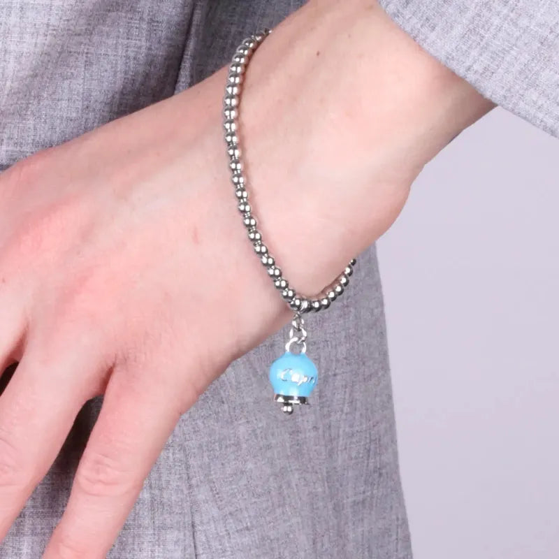 Bracciale in Acciaio  con campanella pendente azzurra  con scritta Capri - BYSIMON gioielli