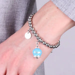 Bracciale in Acciaio  con campanella  azzurra   con scritta Capri - BYSIMON gioielli