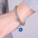 Bracciale in Acciaio  con campanella pendente azzurra   con scritta Capri - BYSIMON gioielli