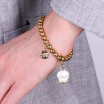 Bracciale in Acciaio  con campanella  bianca e oro  con scritta Capri - BYSIMON gioielli