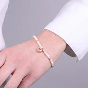 Bracciale in Acciaio con giro di perle e cuore rosa