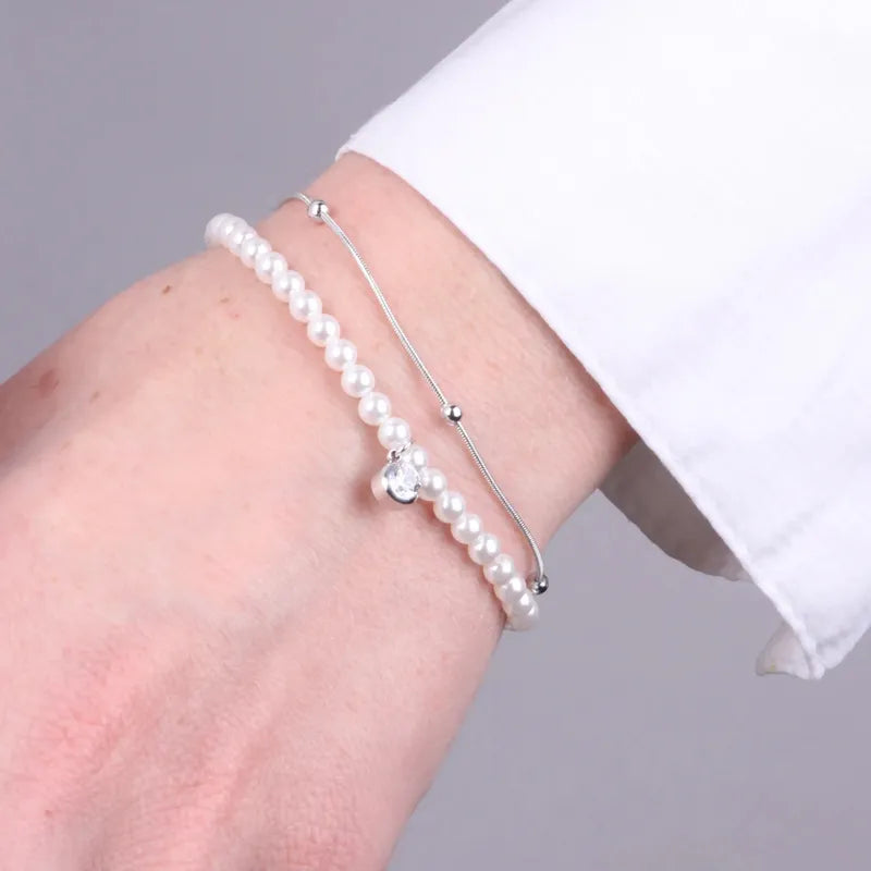 Bracciale in Acciaio doppia catena con perle e punto luce