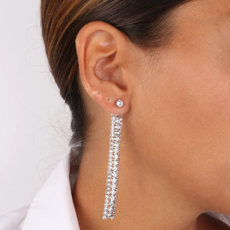 Metal pendant earrings with three strands of crystals and light point closure