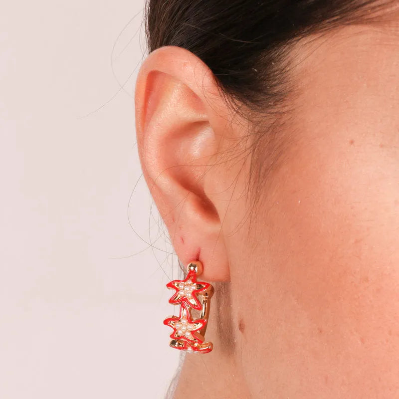 Metal earrings with red starfish
