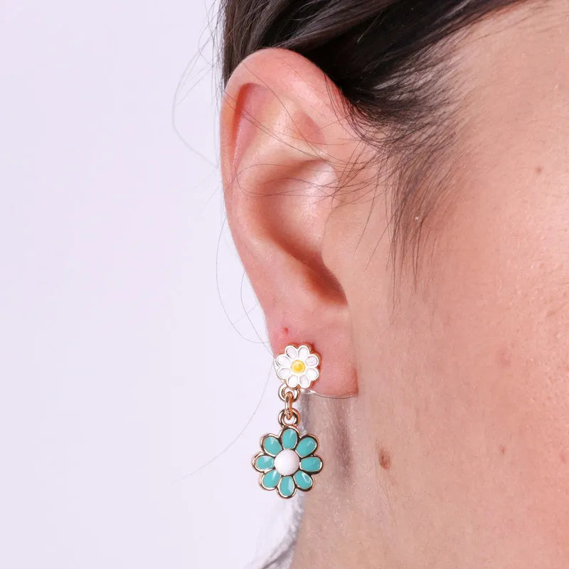 Metal earrings with hanging colored daisies