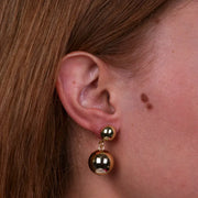 Orecchini in Metallo con perla lucida pendente