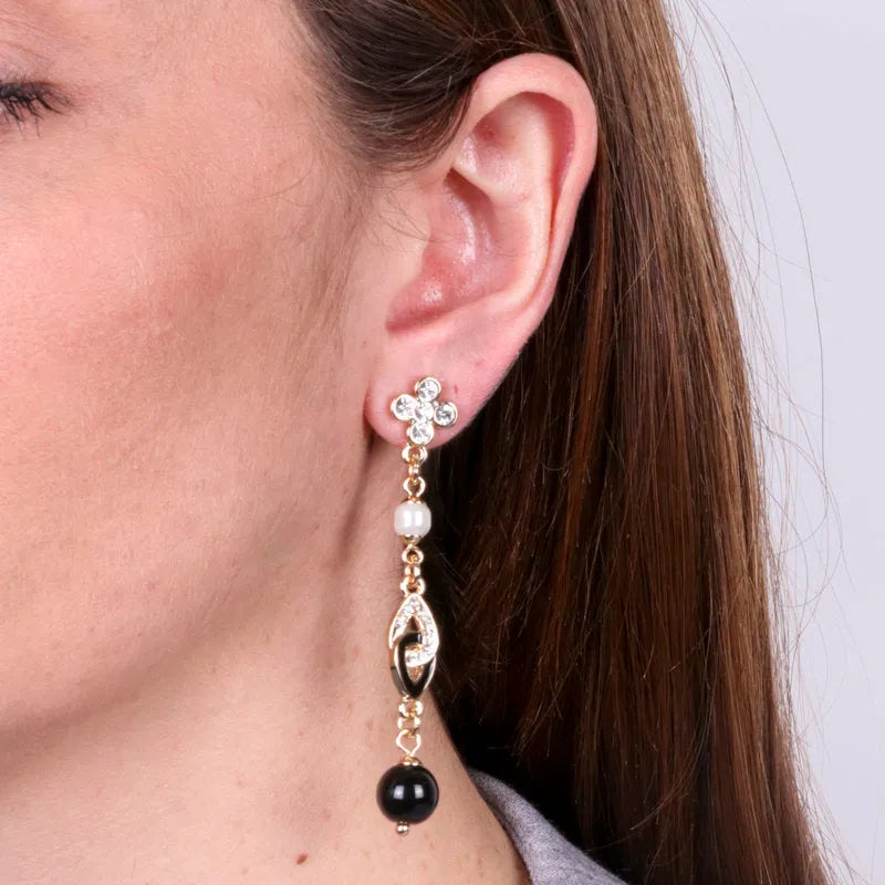 Metal earrings with dangling cross and black pearl