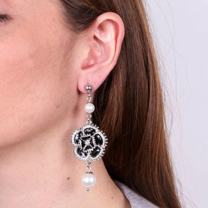 Metal earrings with dangling black flower