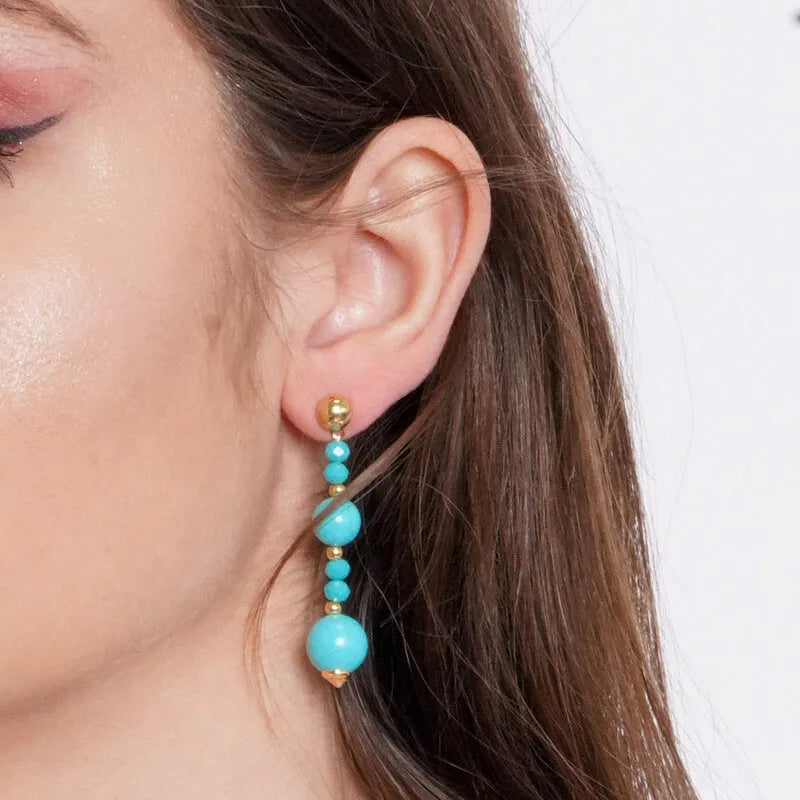 Metal earrings with dangling turquoise stones