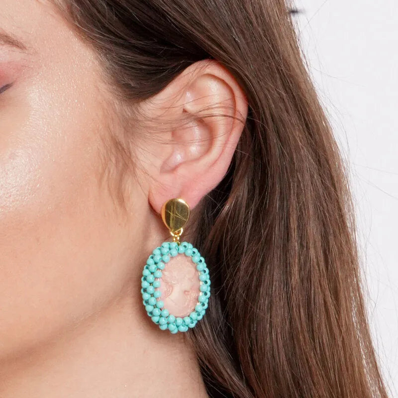 Cameo metal earrings with turquoise spheres
