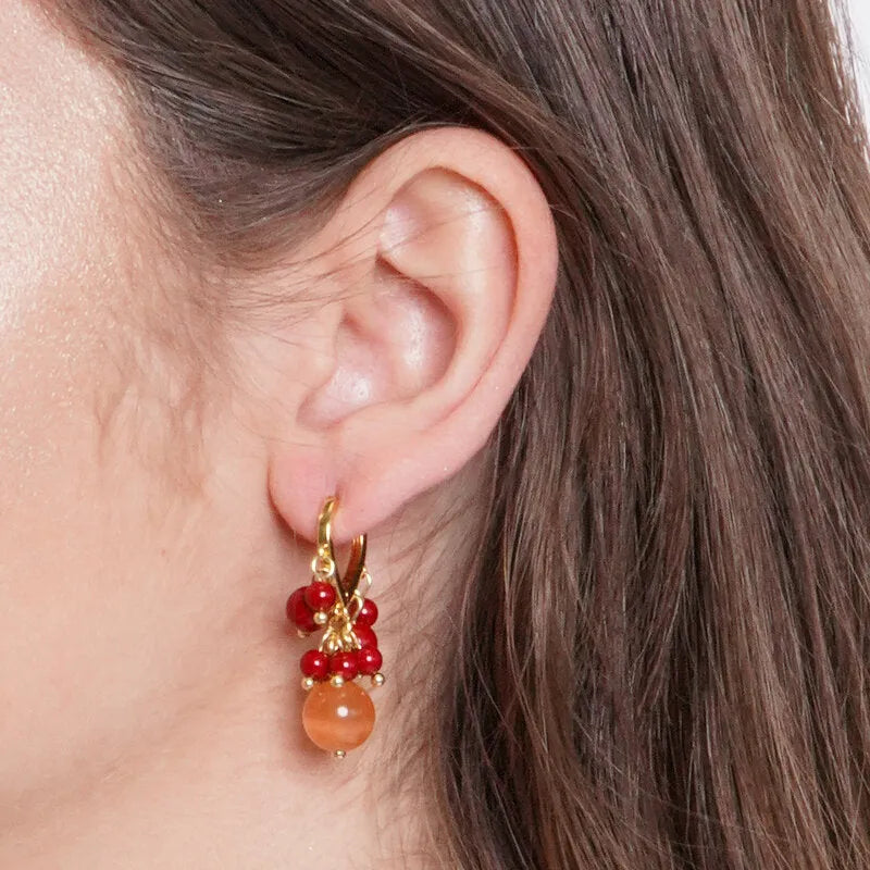 Metal earrings with red and orange spheres