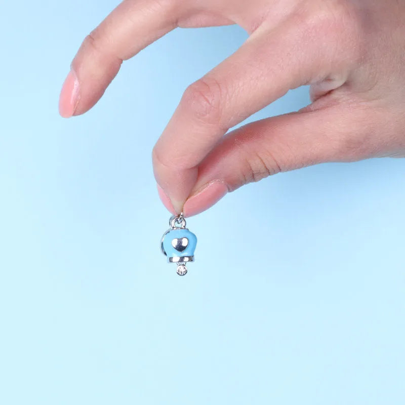 Metal bell-shaped lucky charm pendant, enameled in blue and embellished with crystals