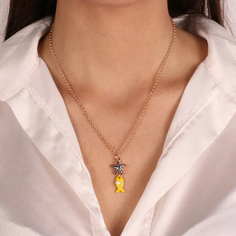 Metal necklace with pendant yellow fish and starfish