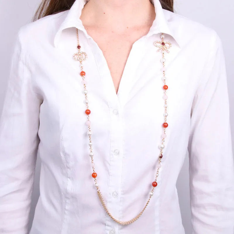Multi-strand metal necklace with bow and pearls