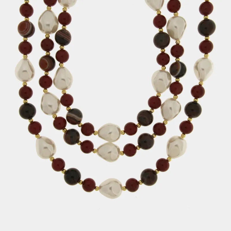 Multi-strand metal necklace with red spheres and pearls