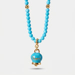 Collana in Metallo con filo di sfere azzurre e campanella con scritta capri - BYSIMON gioielli