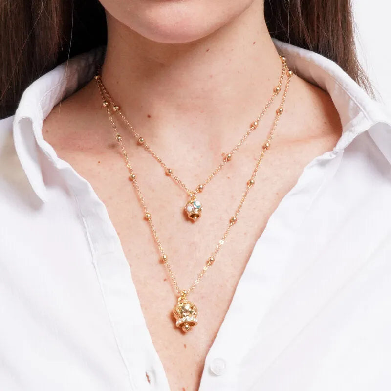 Multistrand gold-plated metal necklace with multicolored bell and gold-plated bell with hearts and zircons