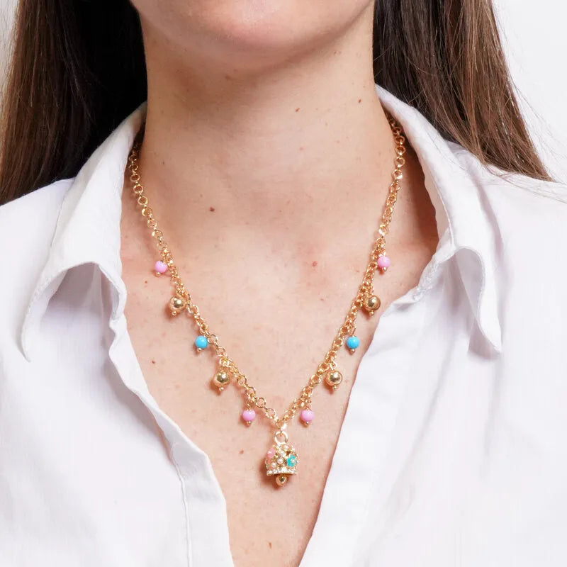 Metal necklace with colored spheres and a bell with raised flowers and crystals