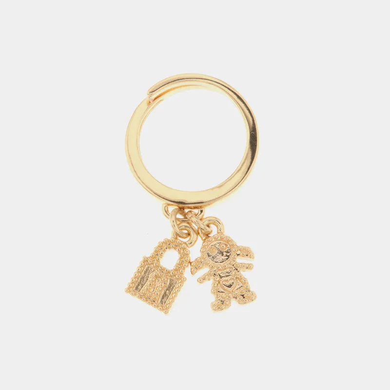Metal ring with child-shaped pendants and padlock