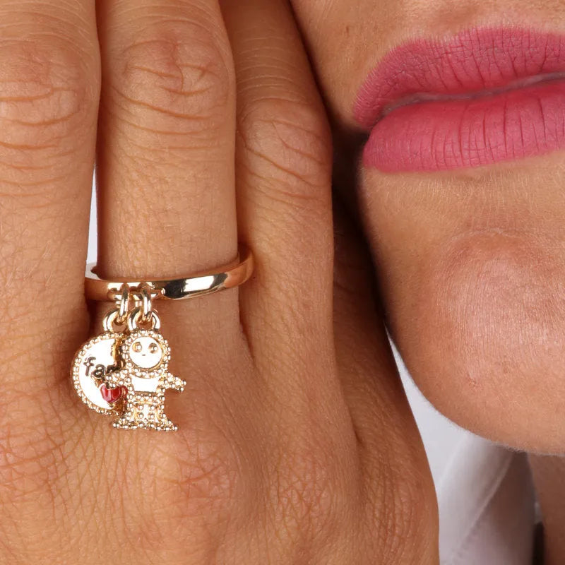 Metal ring with pendants in the shape of a child and family