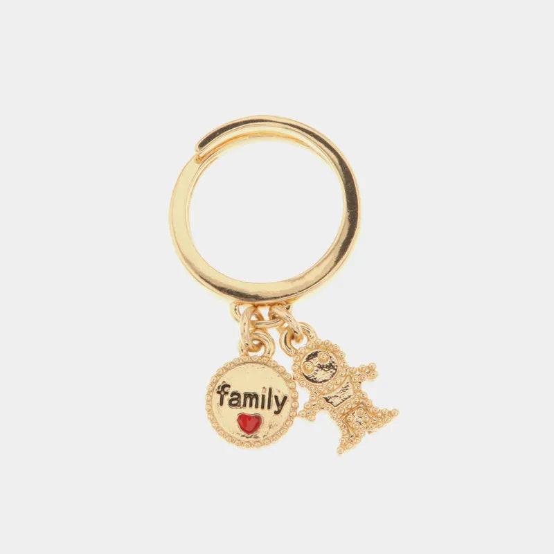 Metal ring with pendants in the shape of a child and family