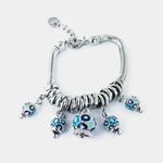Bracciale in Metallo multiciondoli pendenti con campanelle azzurre e cristalli luminosi - BYSIMON gioielli