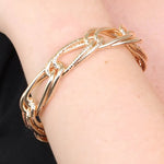 Bracciale in Metallo rigido stile schiava con anelli ad intreccio