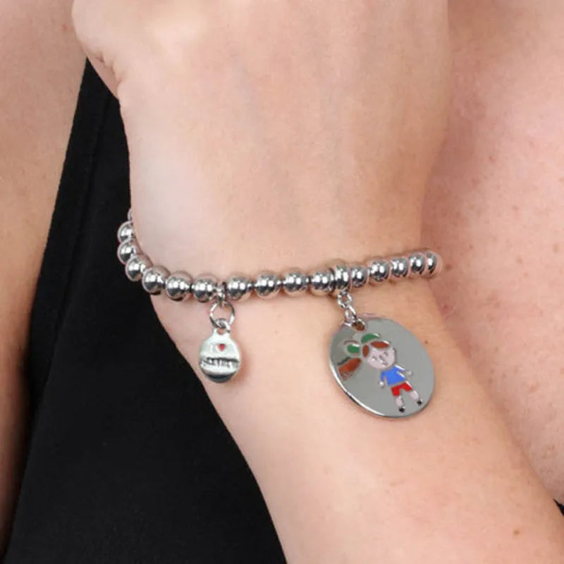 Metal bracelet with child symbol medal embellished with colored enamels