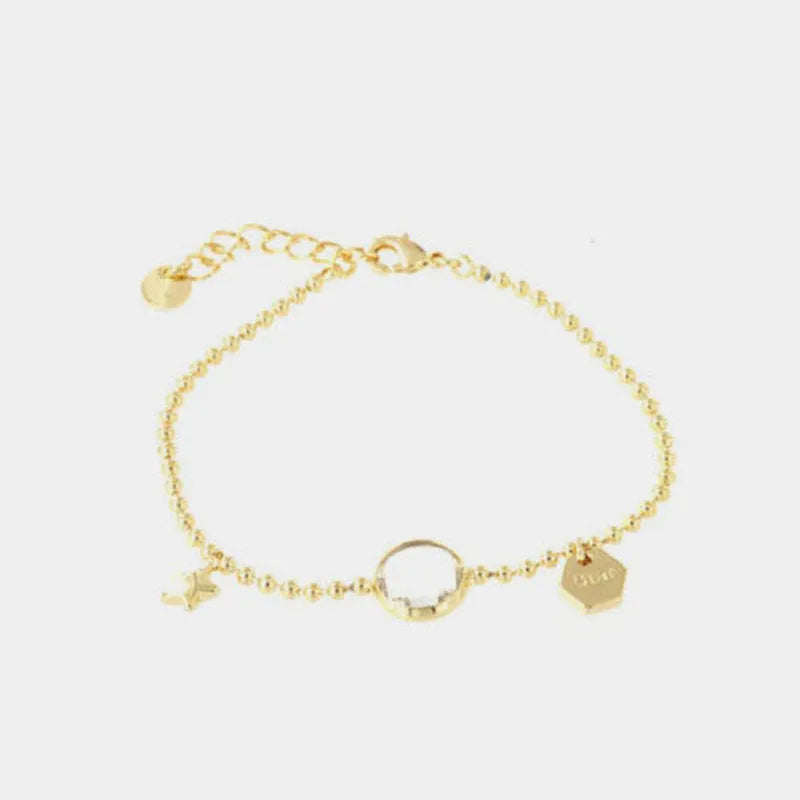Metal bracelet with white crystal and charms