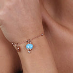 Bracciale in Metallo con campanella portafortuna pendente, impreziosita da smalto turchese e punto luce - BYSIMON gioielli