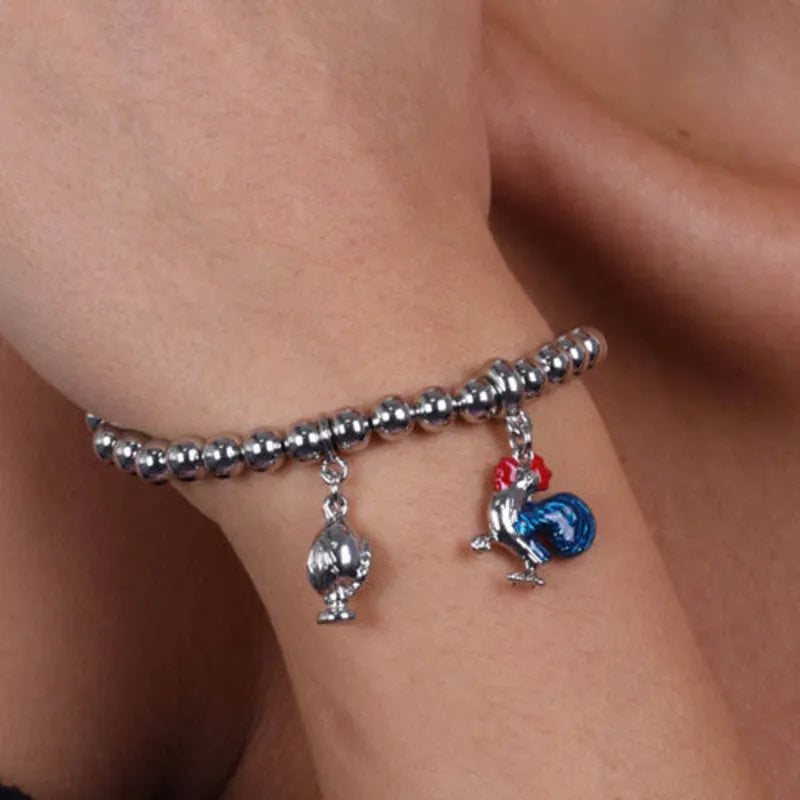 Metal bracelet with rooster pendant embellished with colorful enamels and mini pumo pendant
