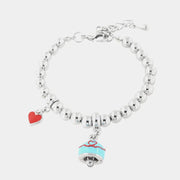 Bracciale in Metallo con campanella turchese e filo rosso con cuore