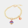 Bracciale in Metallo maglia a sfere, con campana in smalto blu pendente impreziosita da disegno fiocco filo rosso