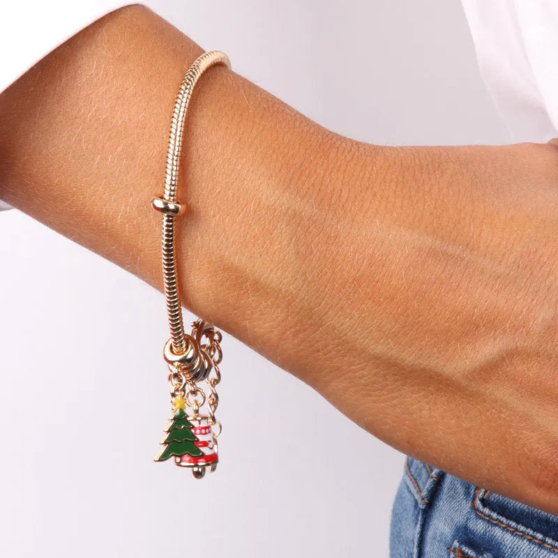 Metal bracelet with tree-shaped pendants and lucky bell