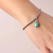 Bracciale in Metallo maglia a sfere con campanella portafortuna pendente  verde acqua impreziosita da cristalli