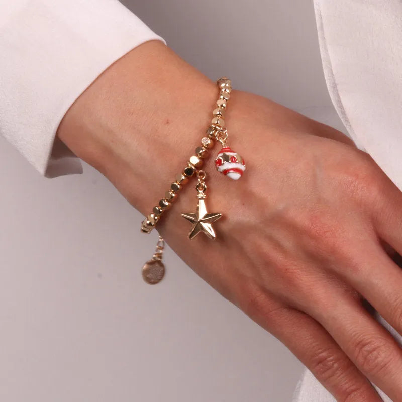 Metal bracelet with star and ball-shaped pendants