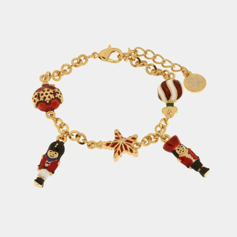 Metal bracelet with ball and nutcracker-shaped pendants