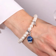 Bracciale in Metallo Bracciale in Metallo con perle e campanella portafortuna in smalto blu con scritta Capri